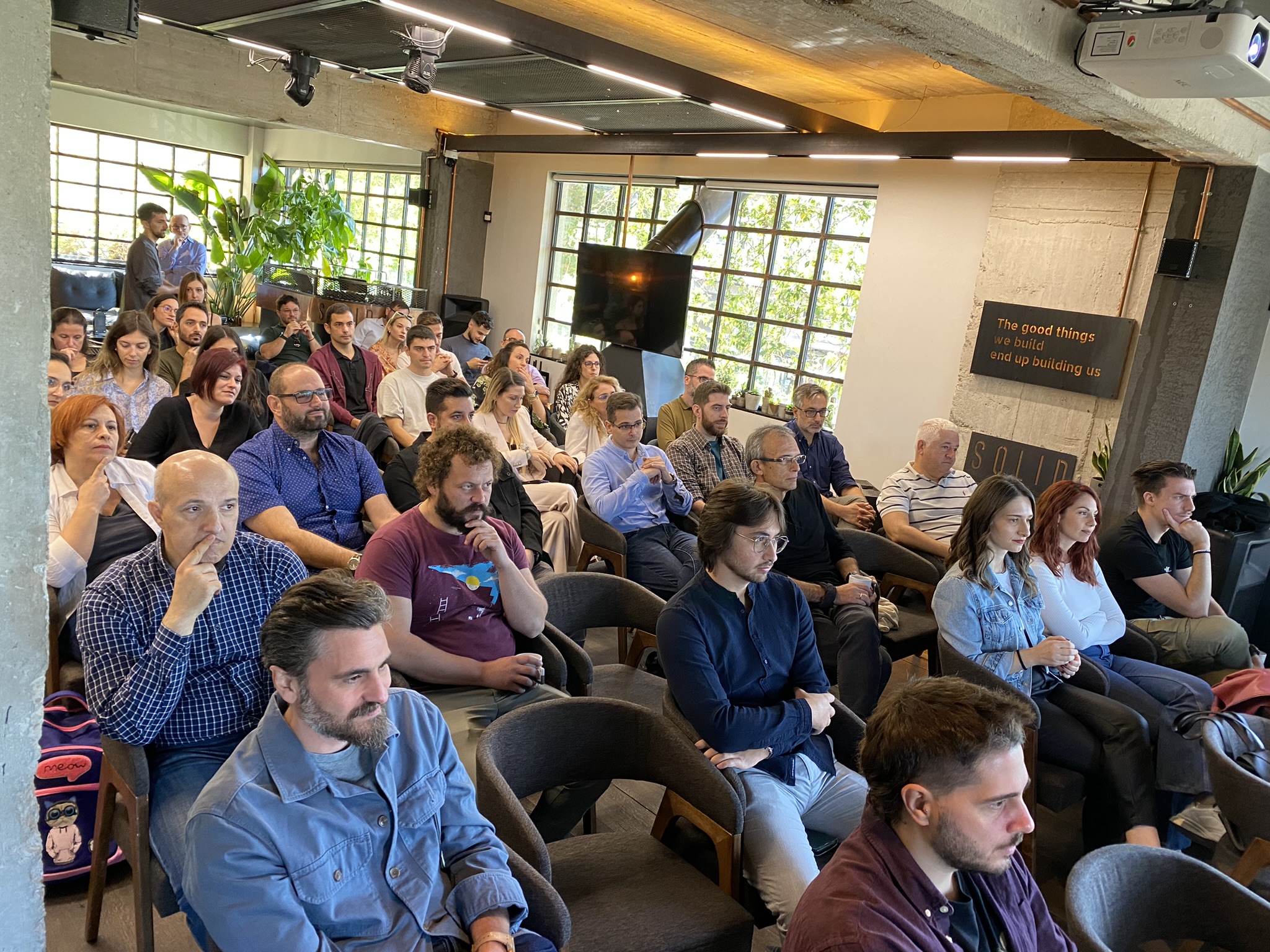 Neurocom event attendees watching an interesting presentation.